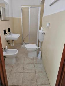 a bathroom with a shower and a toilet and a sink at B apartments 2 in Case Bruciate