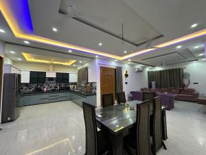 a kitchen and living room with a table and chairs at Hacienda napoles in Chandigarh Airport