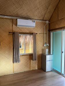 a living room with a window and a heater at Baan Bamboo Koh Tao in Ko Tao