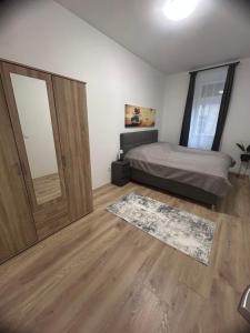 a bedroom with a bed and a large sliding door at R03 Central Residence in Sopron
