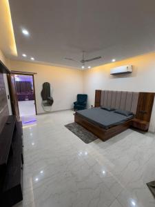a bedroom with a bed and a tv in a room at Hacienda napoles in Chandigarh Airport