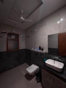 a bathroom with a white toilet and a sink at Hacienda napoles in Chandigarh Airport +14 photos