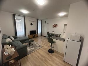 a living room with a couch and a refrigerator at R03 Central Residence in Sopron