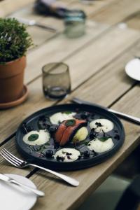 a plate of food on a wooden table at Hofgut Schmitte in Gießen