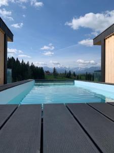 a swimming pool with a view of the mountains at RzepiskaView in Rzepiska