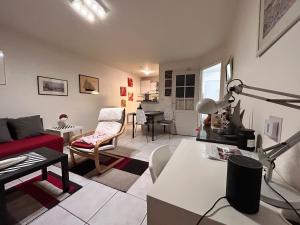 a living room with a red couch and a table at 31 Bd De Launay in Nantes