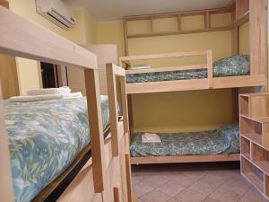 a room with three bunk beds in it at Casa Rita in Civezza