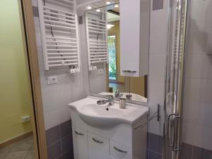 a bathroom with a sink and a mirror at Casa Rita in Civezza