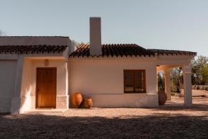 a small white house with a cross on top of it at Casa Valentina Ronda in Ronda
