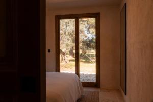 a bedroom with a bed and a large window at Casa Valentina Ronda in Ronda