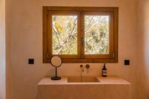a bathroom with a sink and a window at Casa Valentina Ronda in Ronda +20 photos