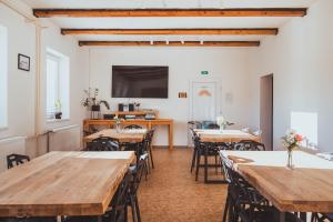 a dining room with wooden tables and chairs at U Ztraceného potoka in Vápenná +60 photos