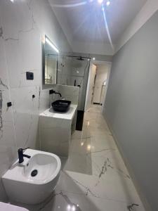 a white bathroom with a sink and a toilet at Casa Leone sea&terrace in Bogliasco +23 photos