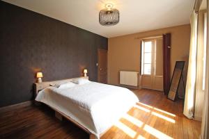 a bedroom with a large bed and a window at Les 3 tilleuls in Bellac