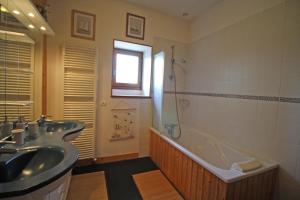 a bathroom with a tub and a sink and a shower at Les 3 tilleuls in Bellac +30 photos
