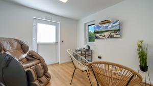 a living room with a leather couch and chairs at Villa Lady Berga by Villas Guide in Ludbreg