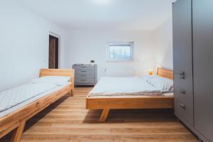 a bedroom with two beds and a dresser at U Ztraceného potoka in Vápenná