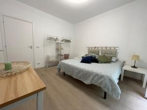 a bedroom with a bed in a white room at Casa Leone sea&terrace in Bogliasco