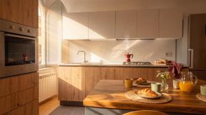 a kitchen with a table with bread on it at Edoardo Historic House in Gubbio