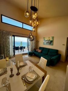 a living room with a green couch and a dining table at Best Vistamar Sea View in Torrox Costa