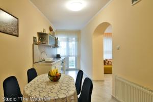 a kitchen with a table with a bowl of fruit on it at Studio The Waterfall - Free Parking in Balchik