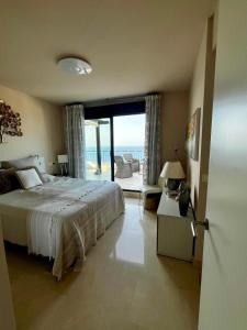 a bedroom with a bed and a view of the ocean at Best Vistamar Sea View in Torrox Costa +52 photos