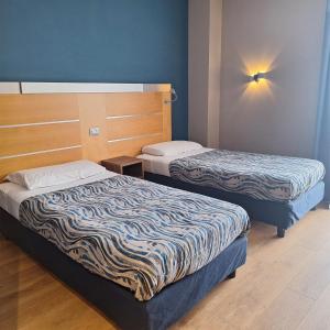 a hotel room with two beds in a room at Idea Hotel Milano San Siro in Milan +44 photos