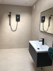 a bathroom with a sink and a mirror at harbourways in Looe +13 photos