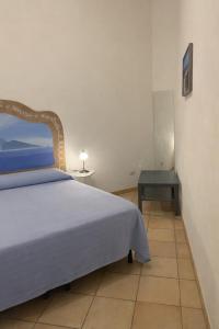 a bedroom with a bed and a side table at Casa Marietta in Lipari