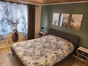 a bedroom with a bed with a deer on the wall at le nid du calice in Abreschviller +29 photos