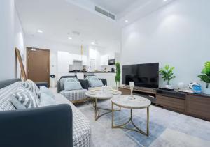 a living room with a couch and a tv at Bohemian Rhapsody in Kuwait