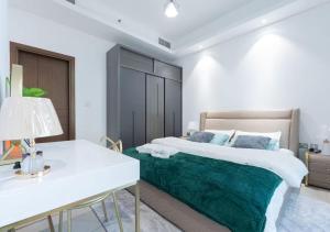 a bedroom with a large bed and a white table at Bohemian Rhapsody in Kuwait