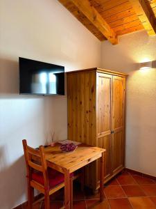 a wooden table and a cabinet in a room at Agri Village Pavia in Certosa di Pavia