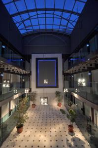 a large hallway with potted plants in a building at No 19 Boutique Hotel in Ankara +24 photos