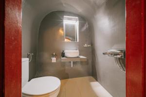 a small bathroom with a toilet and a sink at Alternative Medieval Villa in Kalamoti +11 photos