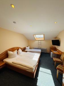 a hotel room with a bed and a television at Hotel Europa Pforzheim in Pforzheim