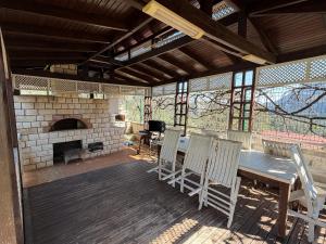 a patio with a table and chairs and a fireplace at Villa Leom - Mountain Villa with Pool in Antalya in Gedeller