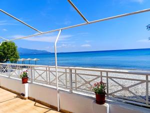 a balcony with a view of the beach at Potokaki Coastal Haven in Potokáki