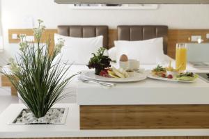 a table with plates of food and a plant on it at No 19 Boutique Hotel in Ankara