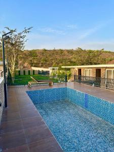 a swimming pool in the middle of a house at Nagpal Farm in Panchkula