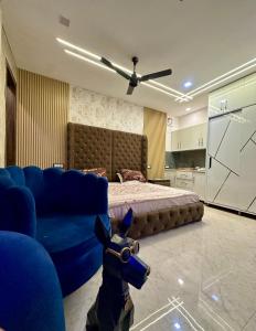 a bedroom with a bed and a blue couch at Nagpal Farm in Panchkula