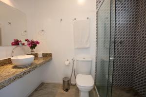 a bathroom with a toilet and a sink and a shower at Saint Germain Wind Residence in Icaraí