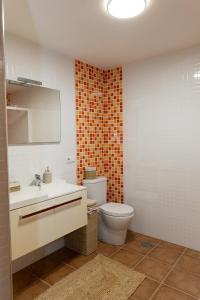 a bathroom with a toilet and a sink and a mirror at Casa San Son in Pontevedra +30 photos