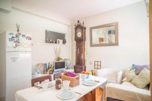a living room with a table and a clock at Alex Point - Guest House in Viana do Castelo