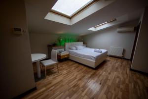 a bedroom with a bed and a table and a skylight at No 19 Boutique Hotel in Ankara