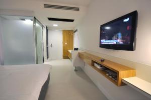 a room with a tv on a wall with a bed at No 19 Boutique Hotel in Ankara