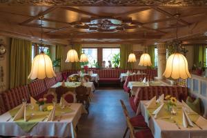 a dining room with tables and chairs and chandeliers at Landhaus Deuber in Weismain