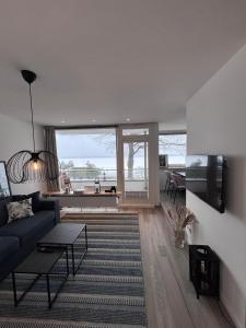 a living room with a couch and a table at Ostseeblick Apartment 2 in Scharbeutz