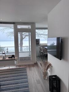 a living room with a large window and a table at Ostseeblick Apartment 2 in Scharbeutz
