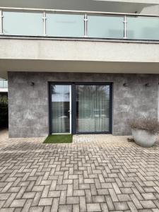 a building with a courtyard with a large glass door at ILK Residence 3 in Balatonalmádi